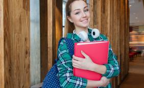 Female learner carrying red file.jpg