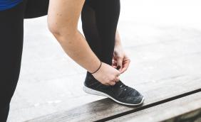 Faceless female tying shoelace.jpg
