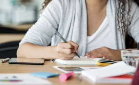 Faceless young female writing.png