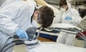 Apprentices working on a car.png